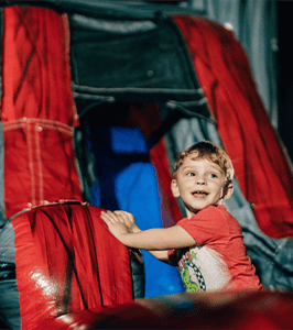 Spooktacular Trunk or Treat fall event at Free Life Chapel - child climbing inflatable slide