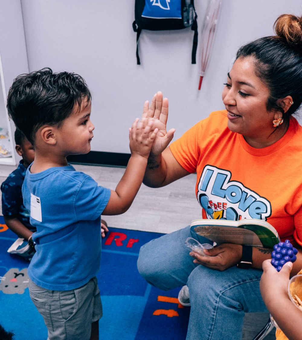 FLC Kids church volunteer high-fiving kid