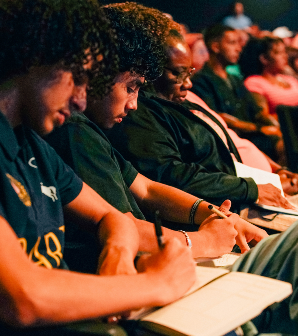 members of Free Life Chapel taking notes during the sermon